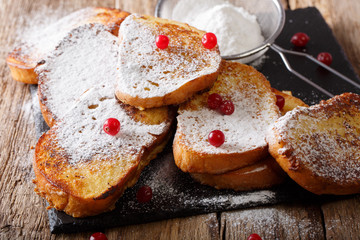 Brazilian sweet toast Rabanadas with sugar powder and berries close-up. horizontal