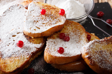 Home sweet tasty toast with powdered sugar and cranberries close-up on the table. horizontal