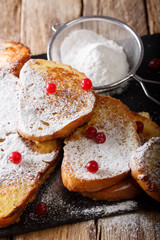 Fried sweet toast with sugar powder and cranberries close-up. vertical