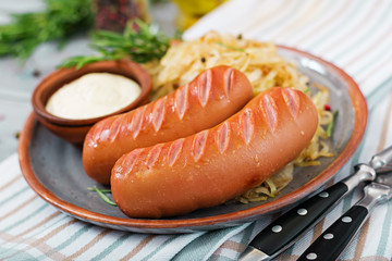 Plate of sausages and sauerkraut on wooden table. Traditional Oktoberfest menu