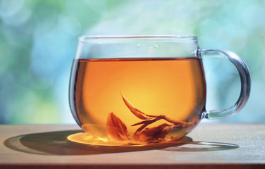Cup tea with tea leaves on the windowsill. Tea time.