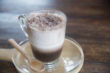 Sweet hot chocolate with whipped cream on wooden table
