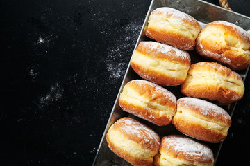 Naklejka premium Sufganiyot donuts with jelly on black background