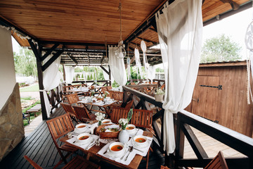 Interior of wedding party decoration in rustic style with a lot of wood and knitted things