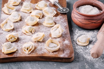 Fototapeta na wymiar Fresh raw homemade tortellini or ravioli pasta
