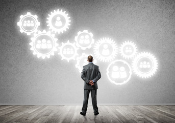 Cogwheel engine drawn on concrete wall as symbol for teamwork and cooperation