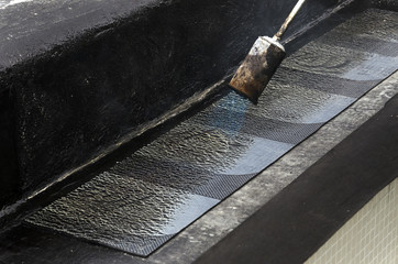 laying of waterproofing sheathing  and insulation during the renovation of a roof in Italy