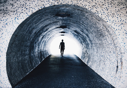 Fototapeta Man walking in tiled tunnel