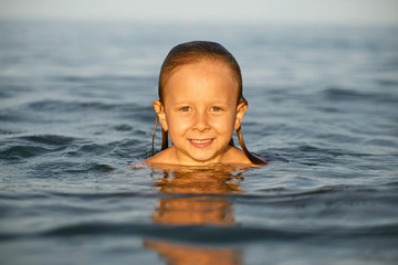 Girl having fun bathing in the sea.