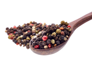 Top view of a wooden spoon full of allspice seeds isolated on white background, shallow depth of field, front focus