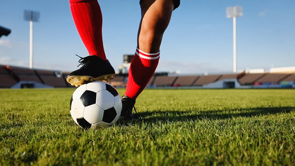 soccer or football player standing with ball on the field for Kick the soccer ball at football stadium © tuiphotoengineer