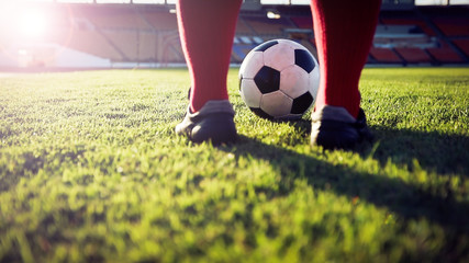 soccer or football player standing with ball on the field for Kick the soccer ball at football...