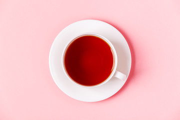 Cup of tea on a pink pastel background