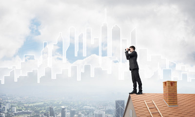 Businessman standing on roof and looking in binoculars. Mixed media