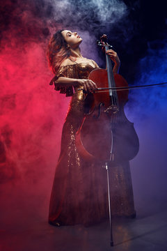 The cellist girl performs on stage.