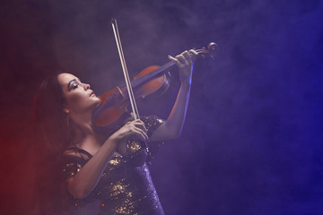 Fototapeta premium Violinist girl performs on stage.