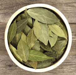 bay leaf dried in bowl on wooden table