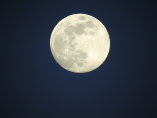 Amazing full moon over the city in the evening