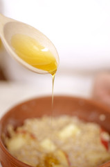 sweet honey dripping from a wooden spoon