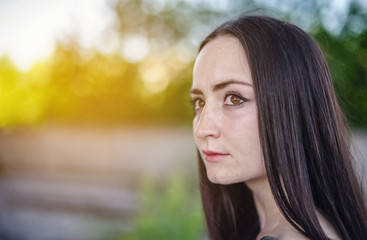 girl will wrinkle to the left against a background of green trees