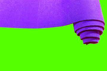 blue sports mat, isolated on green background, healthy lifestyle concept, place for text