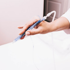 rejuvenation procedure , a woman beautician cosmetologist holds a mesotherapy apparatus