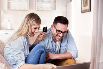 Young couple shopping online at home