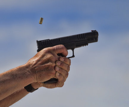 Brass ejecting from a handgun that has just been shot