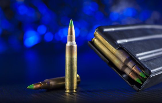 AR-15 ammo and magazine with blue background