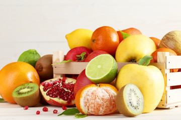 Sliced fruits and whole fruit in a wooden box