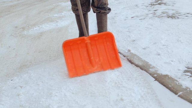 Janitor cleaning the yard of snow