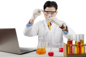 Male scientist mixing chemicals isolated over white background