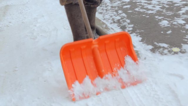 Janitor cleaning the yard of snow