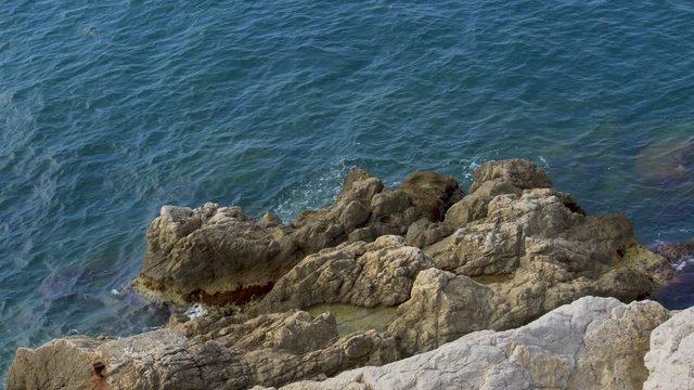 Calm sea waves washing rocky cliff, beautiful nature, relax and recreation