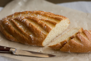 Flavored loaf on the craft paper / on the wooden background