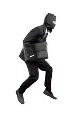 Thief dressed in black and wearing a balaclava stealing a bag