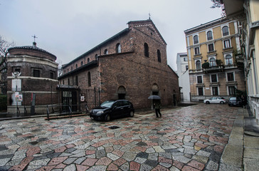 Fototapeta premium a small square inside which the oldest basilica of Milan, Italy