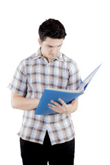 College student standing while write something on his folder