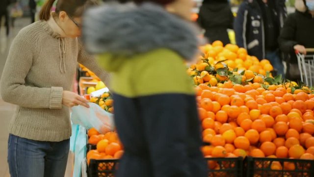 Woman choosing fruit in supermarket