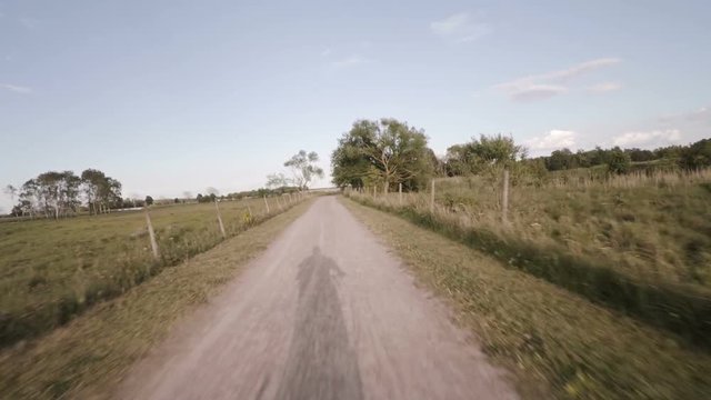 Riding bike on rural road pov film clip in fast motion. Leisure and recreation in swedish countryside.