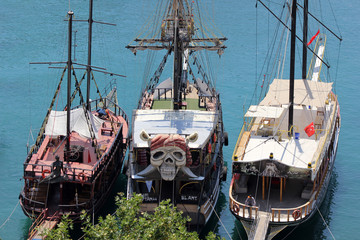 Three pirate ships in the sea at the pier