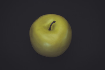 Yellow apple on a wooden background