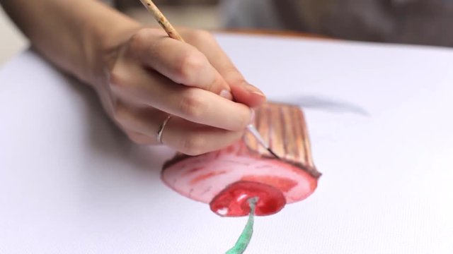 girl draws a capkake in the album