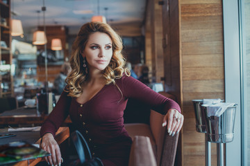 Beautiful Young Woman Waiting in a Cafe