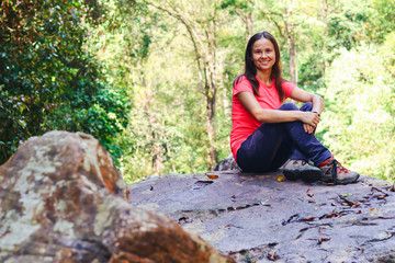Tourist sit on dry waterfall stones