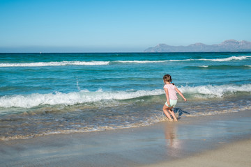 Cute girl walking on the beach