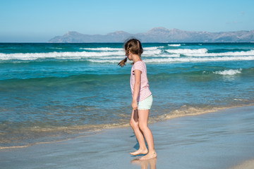 Cute girl walking on the beach