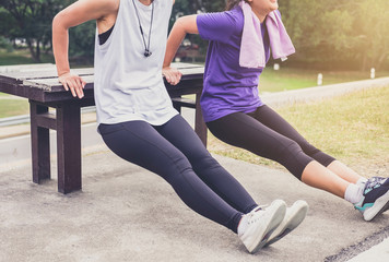 Fototapeta premium Two attractive young muscular women, Athletic woman doing some stretching push-up workout exercises warm up fitness