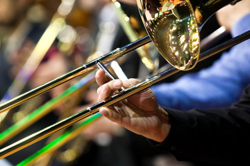  Trombone in the hands of a musician in a closeup orchestra 