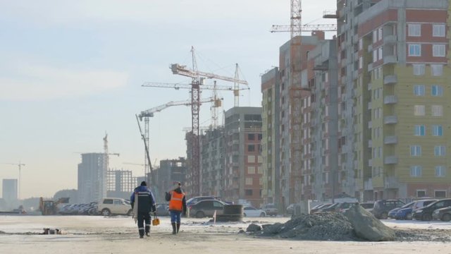 Workers walking to the construction site
